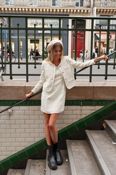 a lady in a white tweed dress and a white tweed coat